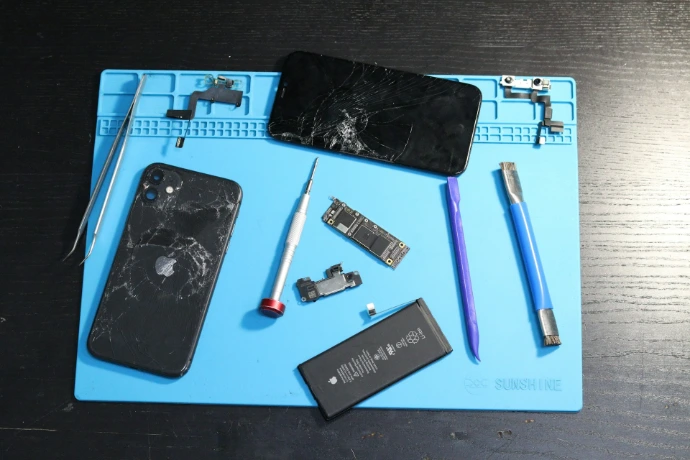 A broken phone disassembled for repair.